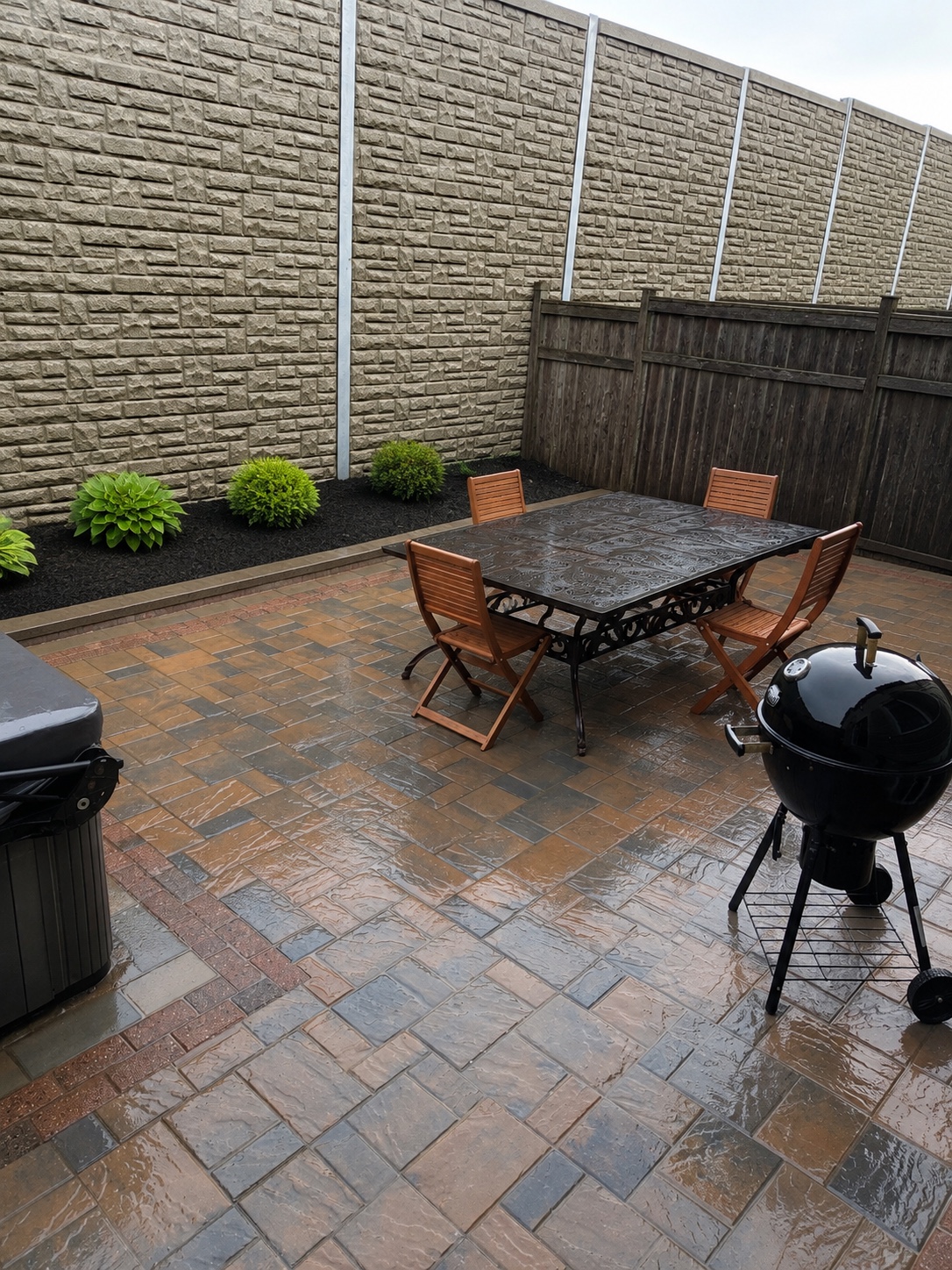 RW Contracting backyard interlock patio with an outdoor dining area